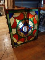 Leaded stained glass panel mounted in metal frame {109 cm H x 98 cm W x 4 cm D}.