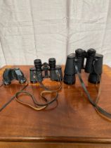 Three pairs of binoculars.