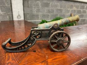Brass and metal model of cannon {22 cm H x 46 cm W x 13 cm D}.