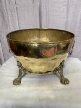 Decorative brass log bucket raised on claw feet. {30 cm H x 47 cm W x 37 cm D}.
