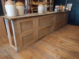 Early 20th C. oak and pitch pine bar counter with panelled front {106 cm H x 447 cm W x 61 cm D}.