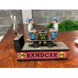 Metal model of Railway Handcar in the form of a money bank {20 cm H x 22 cm W x 8 cm D}.