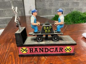 Metal model of Railway Handcar in the form of a money bank {20 cm H x 22 cm W x 8 cm D}.