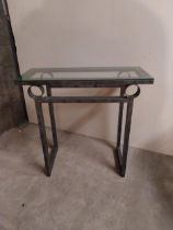 Bronzed metal designer side table with glass top {78 cm H x 82 cm W x 36 cm D}.