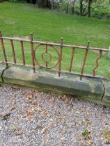 Patio blacksmith wrought iron railings raised on sandstone base {H 56cm x L 630cm x D 23cm}.