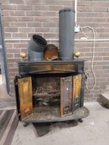 Cast iron stove with brass finials {75 cm H x 100 cm W x 62 cm D}.