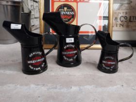 Three Harley Davidson graduated oil measures. {27 cm H x 29 cm W x 15 cm D to 18 cm H x 10 cm W x 10