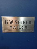 G W Shields Tailor Brass wall sign {H 13cm x W 28cm }.
