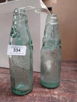 Two 19th C. glass codd bottles - Bewley and Draper Dublin and P Dowd Manchester. {19 cm H}.
