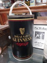 Rare Draught Guinness tin plate glass holder in the form of a Guinness can. {36 cm H x 22 cm Diam}.