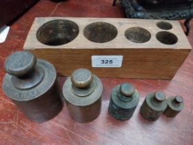 19th C. five brass weights in original case. {8 cm H x 20 cm W x 6 cm D}.