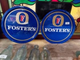 Two Foster's tinplate drink's trays {30cm Dia}.
