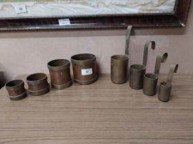 Two sets of copper and brass measures {7 cm