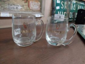 Two Guinness half pint glasses. {10 cm H x 10 cm Dia.}.