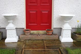 Pair of cast iron urns and bases in the Georgian style. {H 87cm x D 51cm }.