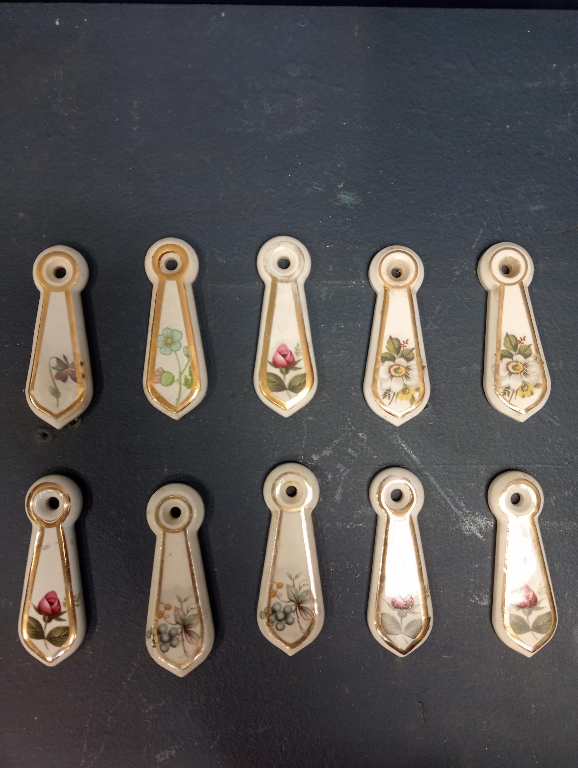 Collection of ten ceramic keyhole covers {H 7cm x W 2cm }.
