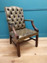 Deep buttoned leather Gainsborough arm chair in the Georgian style {105 cm H x 60 cm W x 65 cm D}.