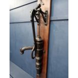 19th C. cast iron wall pump on oak back panel. {H 133cm x W 36cm x D 41cm }.