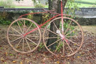 19th C. Bone shaker bicycle with wooden wheels and leather saddle {H 133cm x W 177cm}.