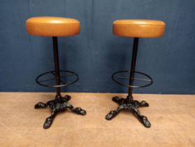 Pair of cast iron stools with leather upholstery {H 76cm x Dia 36cm}.