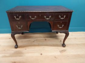 Edwardian mahogany desk with inset leather top and brass handles raised on cabriole legs and ball