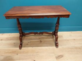 Good quality 19th C. mahogany side table raised on turned legs, single stretcher and four outswept