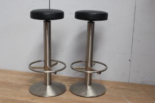 Pair of stainless steel bar stools with leather upholstered swivelled seats {H 85cm x Dia 34cm }.