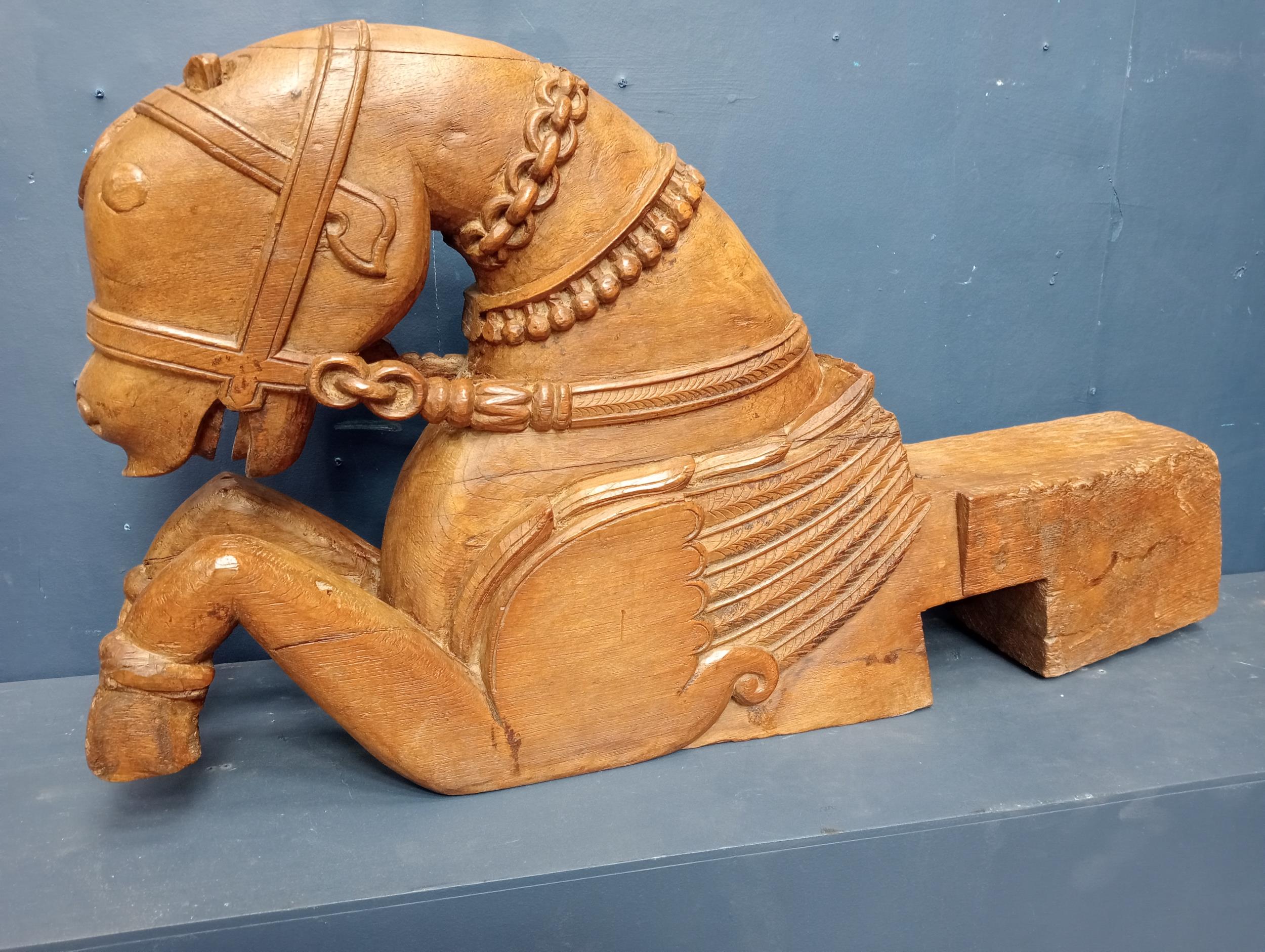 Carved wooden figural corbel in the form of a horse. {H 43cm x W 15cm x D 85cm}.