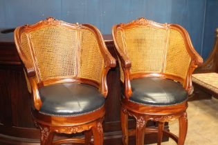 Pair of mahogany swivel high stools with black leather upholstered seat and bergere back {H 129cm