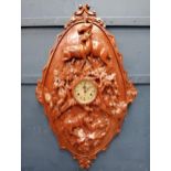 Carved wood wall clock with animal and foliage decoration. {H 100cm x W 60cm x D 10cm}.