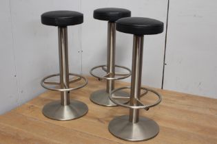 Three stainless steel bar stools with leather upholstered swivelled seats {H 75cm x Dia 40cm }.