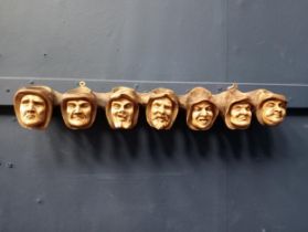 Seven hooded monks heads hanging pipe rack and match holder. {H 6cm x W 49cm x D 7cm }.
