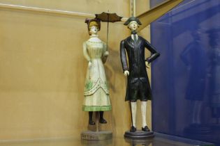 Pair of wooden lady and gent figures {H 37cm x Dia 9cm}.