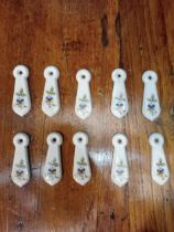 Five pairs of ceramic keyhole covers {H 7cm x W 2cm }.