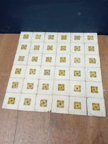 Thirty six ceramic floral wall tiles {51 x 51 each tile 8 1/2 sq}.