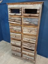 Fourteen drawer driftwood chest {H 146cm x W 75cm x D 42cm}.