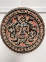 Carved wooden plaque of Medusa. {Dia 52cm }.