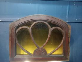 Mahogany arched fanlight with coloured glass insert. {H 66cm x W 84cm x D 19cm}.