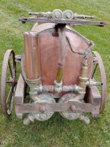 Copper and brass orchard sprayer on metal wheels {H 80cm x W 62cm x D 129cm }.