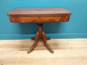 Good quality Regency flamed mahogany turn over leaf card table raised on turned columns, four