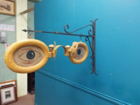 Painted metal hanging Optician's sign with bracket. {69 cm H x 97 cm W x 17 cm D}.