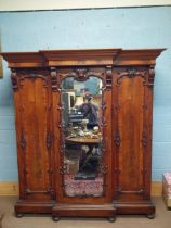 19th C. Mahogany three door wardrobe decorated with carved Prince of Wales feathers and crowns {