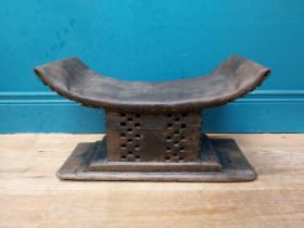 African hardwood stool with upholstered seat. {23 cm H x 46 cm W x 15 cm D}.