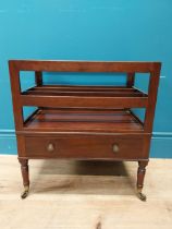 Georgian mahogany canterbury raised on four turned legs with brass casters and single drawer. {51 cm