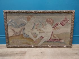 18th C. French tapestry depicting cherubs holding floral wreath mounted in carved giltwood frame. {