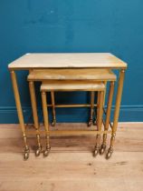 Nest of three brass and onyx tables on casters. {54 cm H x 50 cm W x 32 cm D}.