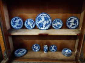 Eighteen blue and white oriental plates and a blue and white oriental vase.