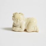 An Ivory Carving of a Recumbent Boy, 19th Century, 清 牙雕童子, length 2.2 in — 5.7 cm