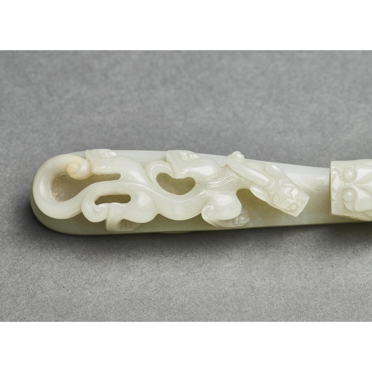 A Pale Celadon Jade 'Dragon' Belt Hook, Qing Dynasty, 清 青白玉雕'苍龙教子'带扣, length 5 in — 12.8 cm - Image 4 of 8