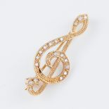 9k Yellow Gold Pin, formed as a treble clef and set with 19 small brilliant cut diamonds